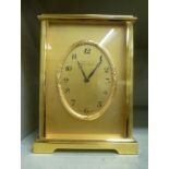 A modern Imhof lacquered brass cased carriage style mantel timepiece with straight sides and a