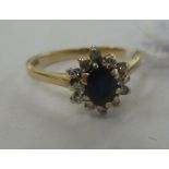 A 9ct gold claw set sapphire and diamond cluster ring 11