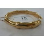 A yellow metal bamboo effect hollow bangle 11