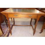 An Edwardian satin mahogany writing table, the top with a tooled and gilded green hide scriber,