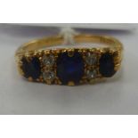 An 18ct gold ring set with alternating diamonds and sapphires 11