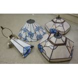 Four similar modern Tiffany inspired lampshades, each decorated with pastel coloured,