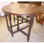 A mid 19thC stained oak gateleg table with an oval top and an end drawer,