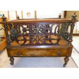 A late Victorian mahogany Canterbury with a fretworked panelled superstructure,