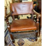 An early 20thC rustically constructed oak elbow chair,