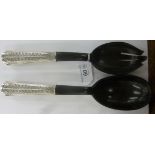 A pair of Oriental silver coloured metal handled horn salad servers 11