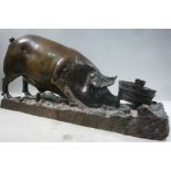 A cast and patinated bronze model, a sow attempting to upturn a bucket,