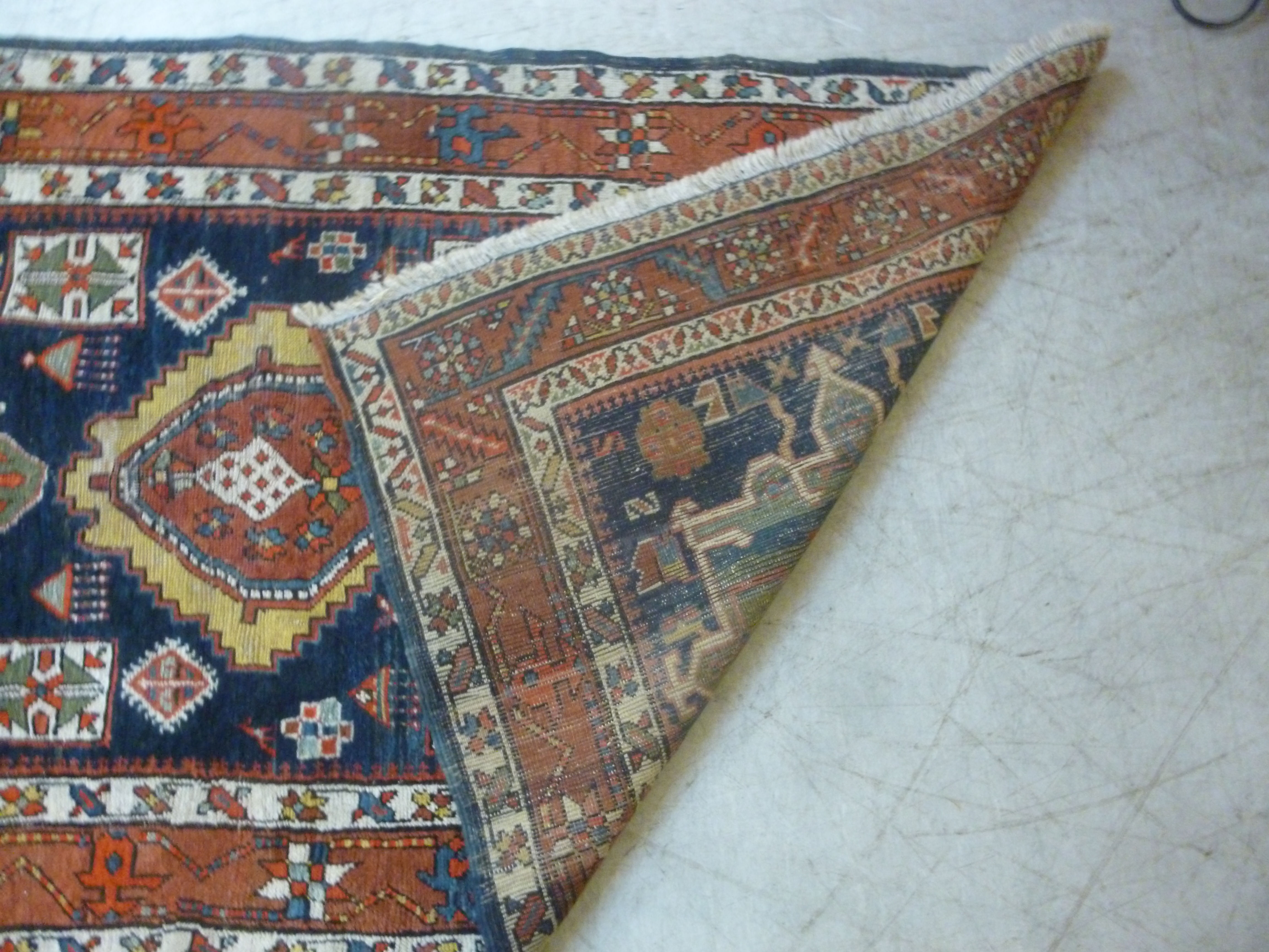 A Caucasian runner with repeated stylised diamond motifs on a blue and red ground 154'' x 39'' - Image 5 of 5