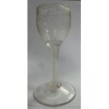 A late 18thC wine glass, the cup shaped bowl with engraved floral sprigs, drapes and swags,