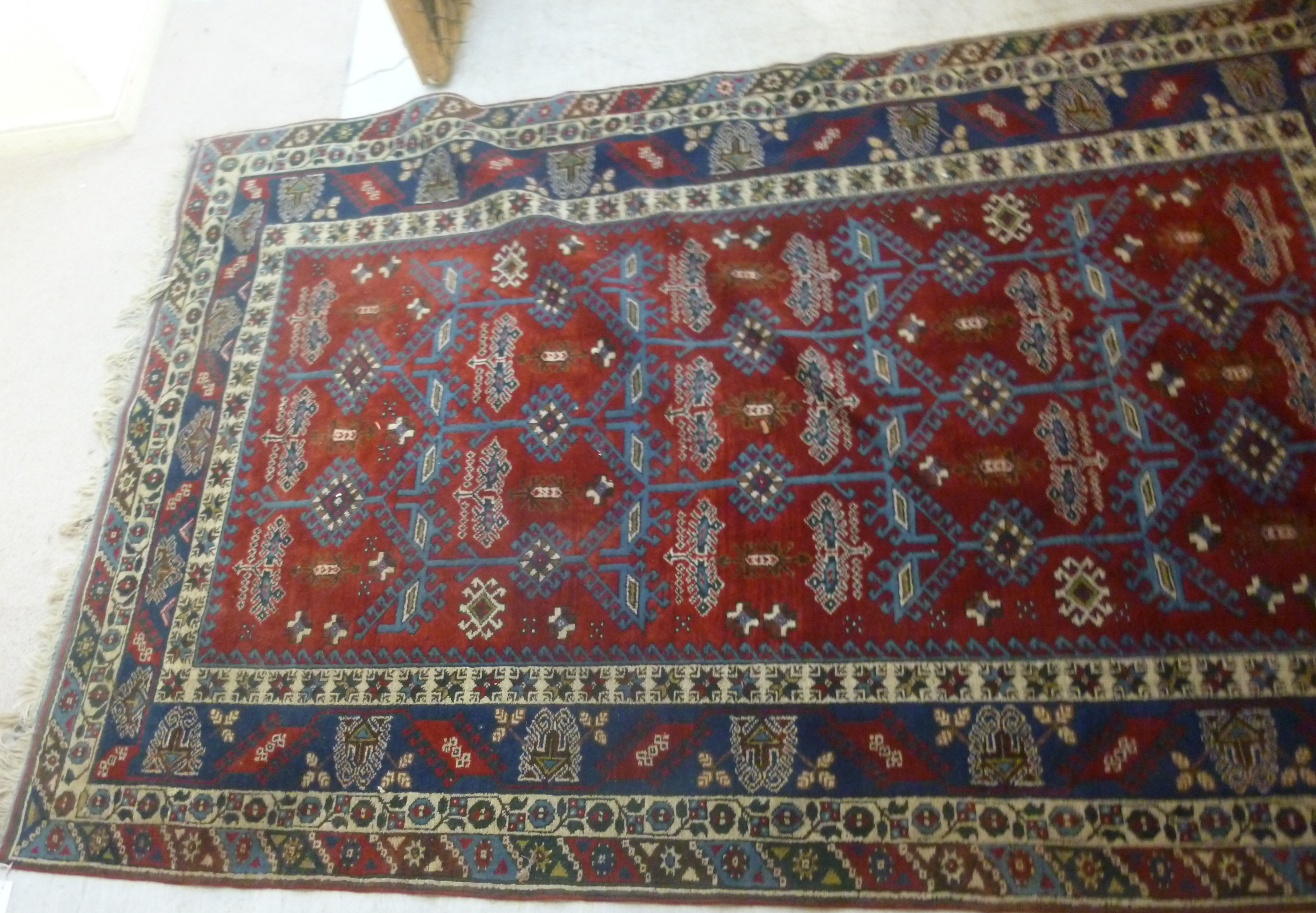 A Turkish carpet with stylised designs on a blue and red ground 110'' x 77'' - Image 3 of 5