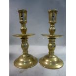 A pair of 18thC Dutch Heemskerk brass candlesticks,