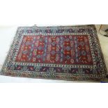 A Turkish carpet with stylised designs on a blue and red ground 110'' x 77''
