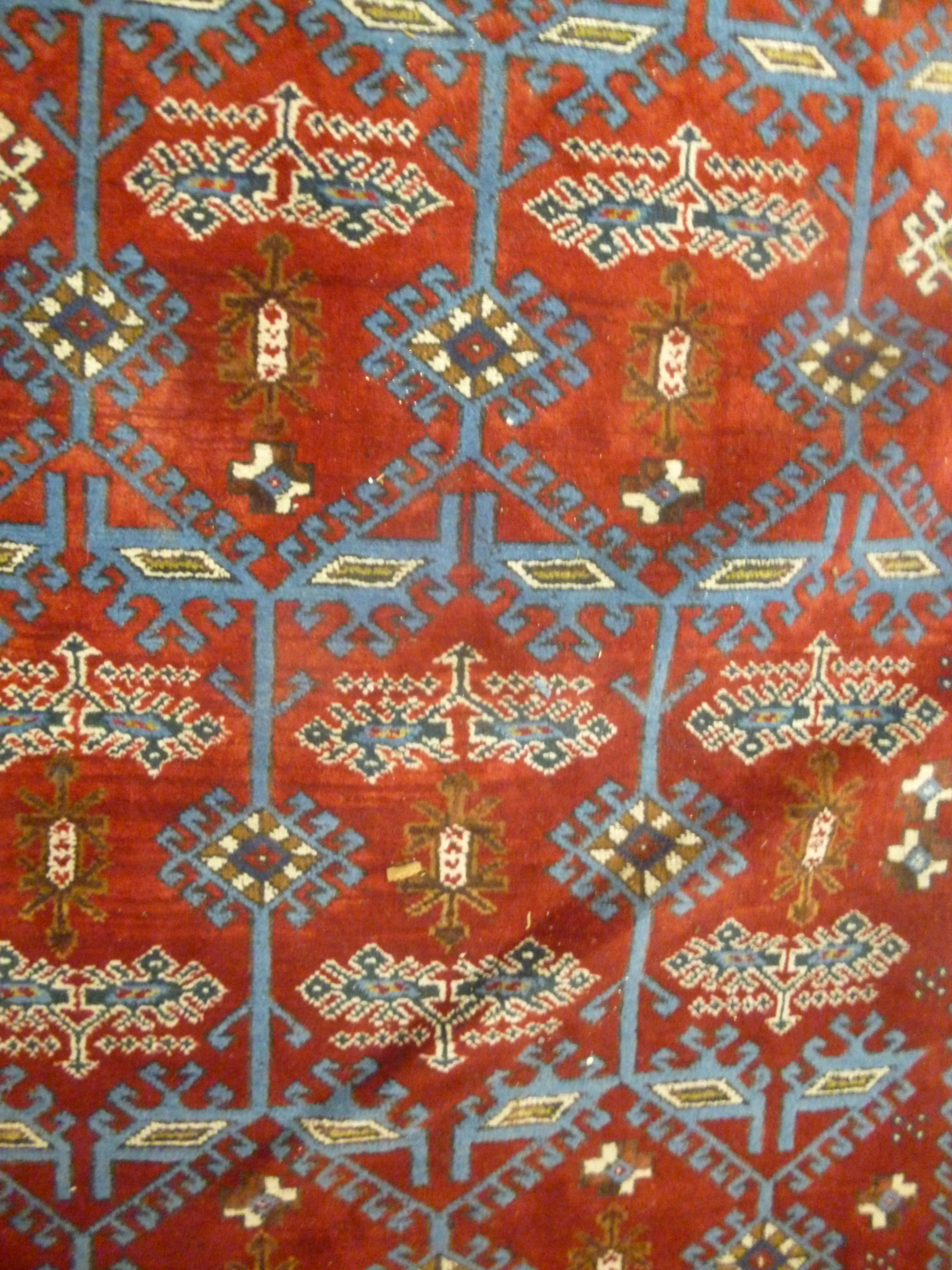 A Turkish carpet with stylised designs on a blue and red ground 110'' x 77'' - Image 4 of 5