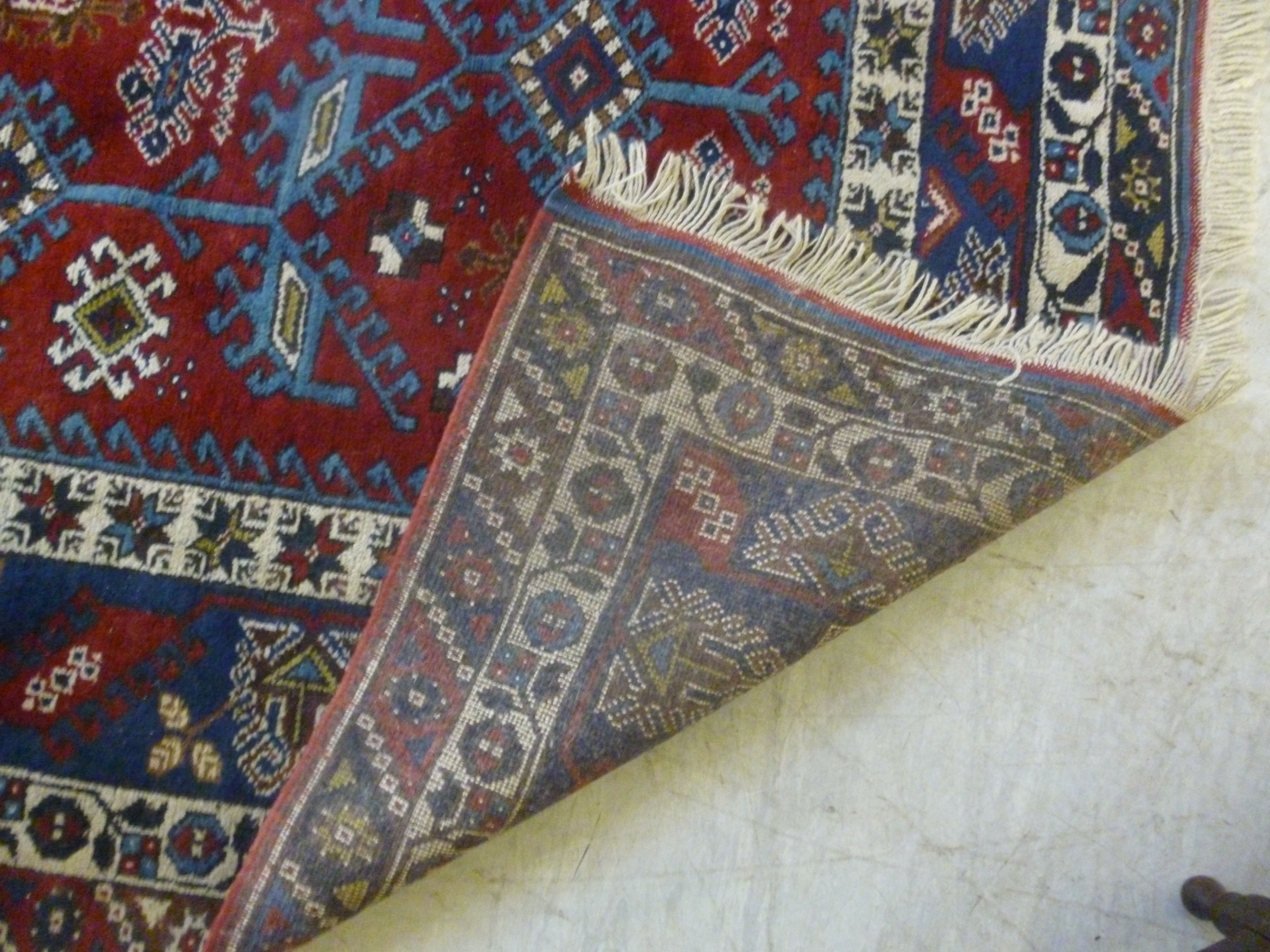 A Turkish carpet with stylised designs on a blue and red ground 110'' x 77'' - Image 5 of 5