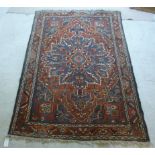 A Persian rug with stylised flora on a red ground 80'' x 54''