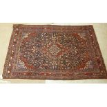 A Caucasian rug with central diamond medallion bordered by stylised designs 84'' x 53''