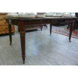 A William IV inspired mahogany double D-end dining table, raised on turned,