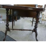 A late Victorian walnut centre table with a serpentine outline top, raised on twin,