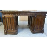 A late Victorian mahogany desk, the top with a canted,