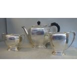 A three piece silver tea set of panelled, elongated,