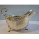 A silver sauce boat with an applied wire rim and a C-scrolled handle,