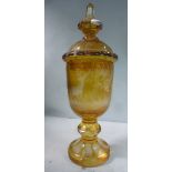 An early 20thC Bohemian amber coloured glass chalice vase and cover,