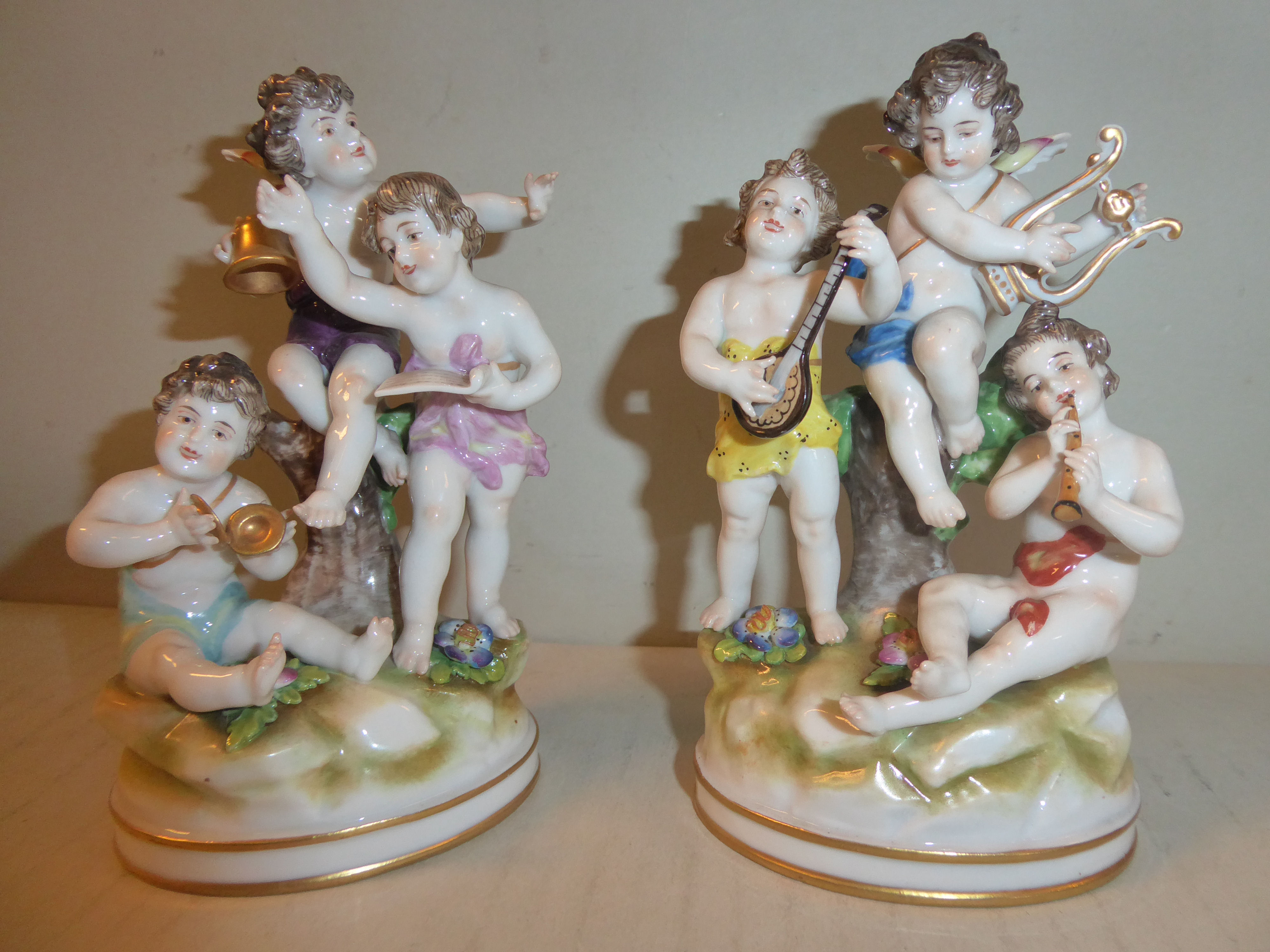 A pair of early 20thC Naples porcelain groups, cherubs playing musical instruments 5.