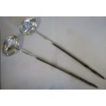 Two similar late 18th/early 19thC silver coloured metal oval punch ladles with flared rims,