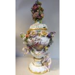 An early 20thC German ivory glazed, floral encrusted, gilded and painted porcelain, twin handled,