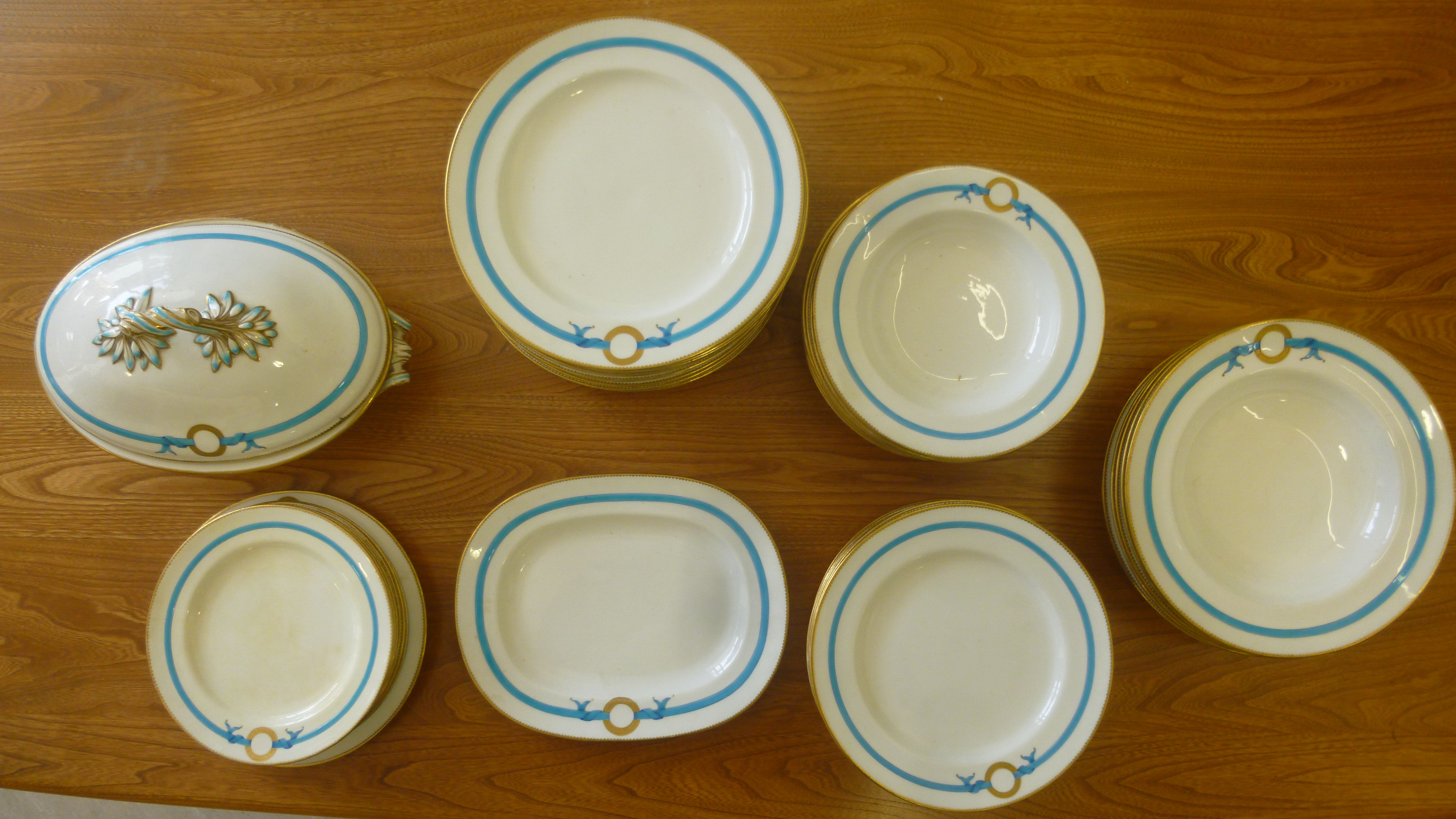 Late Victorian Minton ivory glazed china tableware, the borders decorated with turquoise ribbons,