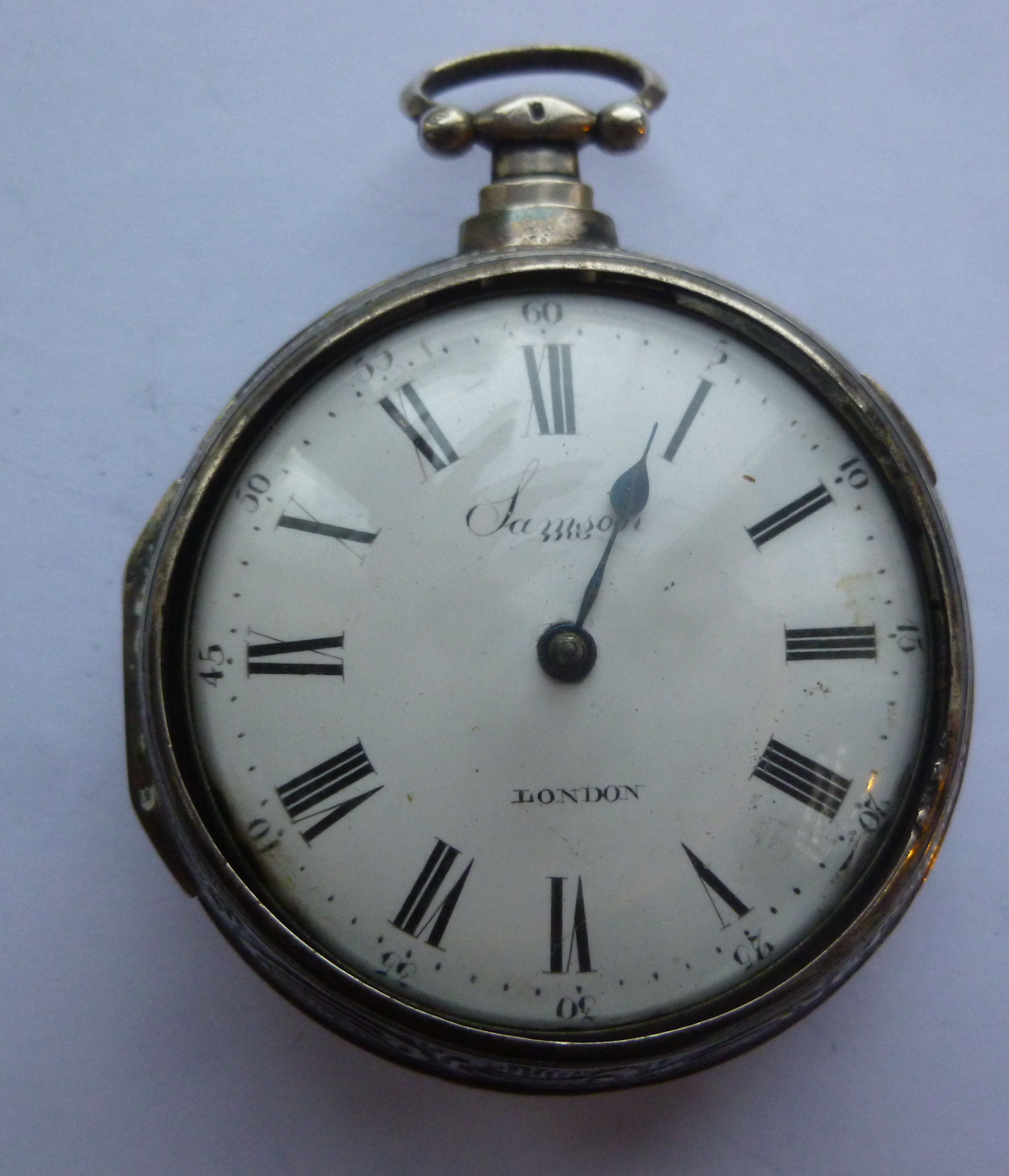 A late Victorian silver pair cased pocket watch, ornately embossed with a Biblical scene,