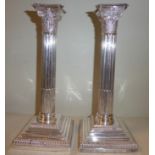 A pair of Edwardian loaded silver candlesticks,