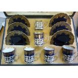 An Edwardian Aynsley china coffee set comprising five cans and six saucers,