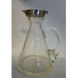 An Edwardian glass whisky tot decanter of tapered, cylindrical form with a drawn loop handle,