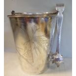 A Chinese silver coloured metal ice bucket of tapered form with a swing handle and engraved,