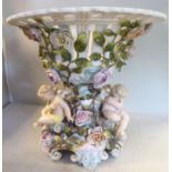 An early 20thC German ivory glazed, floral encrusted centrepiece, featuring a pierced basket,