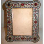 A late Victorian gilt metal photograph frame with outset turret corners and a rectangular aperture,