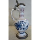 An 18thC German/North European Delftware ewer of bulbous form with a long narrow neck, loop handle,