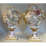 A pair of Chamberlains Worcester ivory glazed and floral encrusted gilded and painted pear shaped,