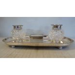 A late Victorian silver standish with gadrooned border ornament, the oval tray on button feet,