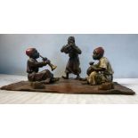 A painted cold cast bronze group, three young Arab musicians,