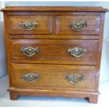 An early 20thC honey coloured oak desktop collectors cabinet,