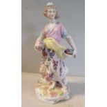 A mid 19thC Sitzendorf porcelain allegorical figure, a woman wearing a floral skirt,