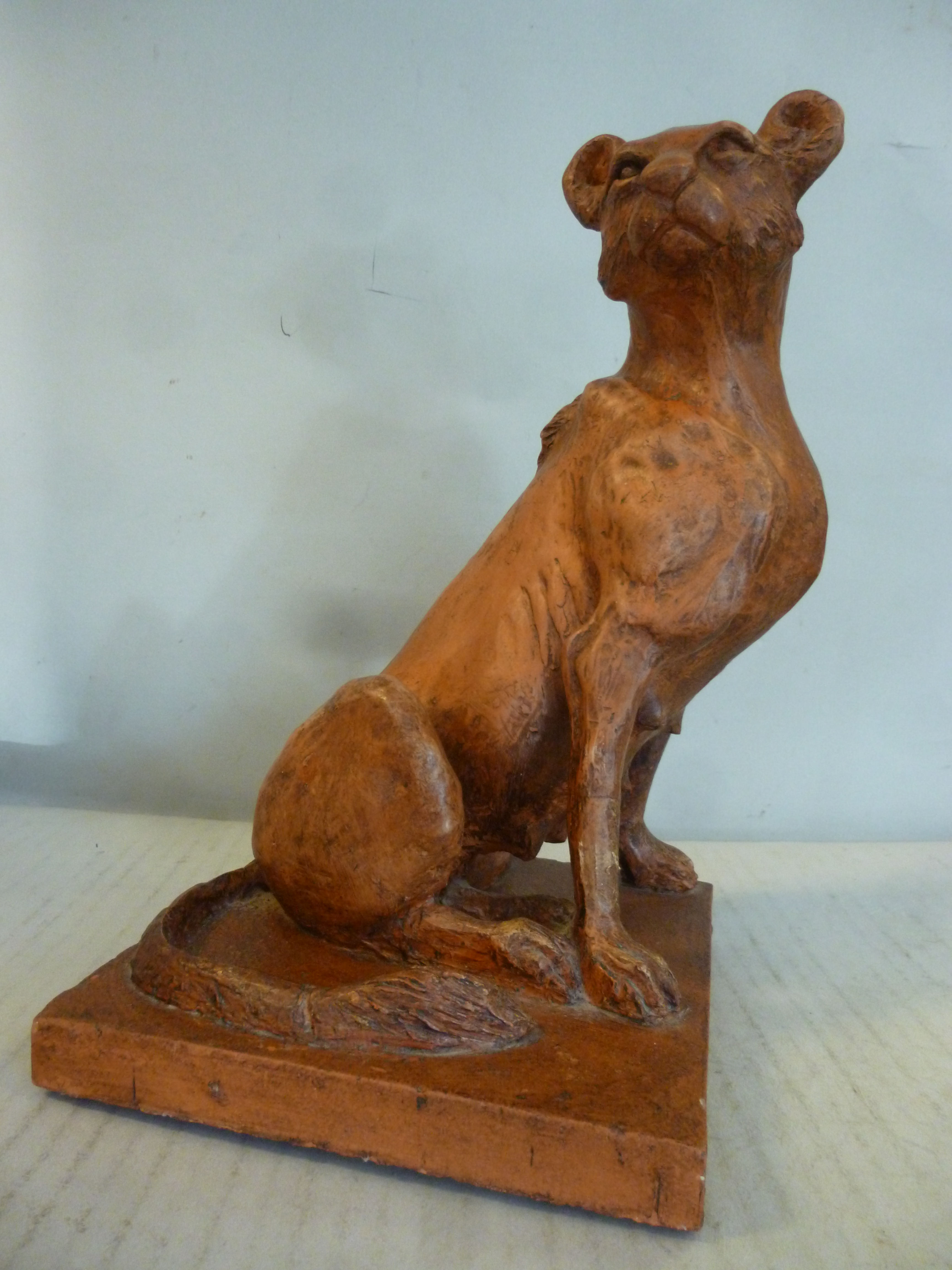 Ajacques - a terracotta model, a stylised seated lioness,