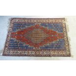A Caucasian rug with a central medallion and concentric designs,