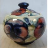 A Moorcroft pottery bulbous, footed bowl and cover with a bun knop,