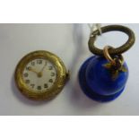 An early 20thC enamelled blue and silver gilt cased bell design pendant watch,