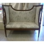 An early 20thC small string inlaid mahogany showwood framed boudoir settee with a high back and