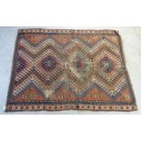 A Kazak rug with four concentric diamond motifs on a terracotta ground 67'' x 51''