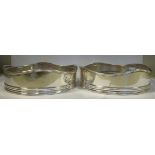 A pair of early 19thC silver wine coasters with straight sides and wavy edged, applied wire rims,